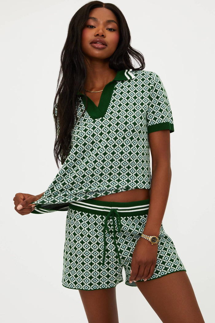 Woman wearing a green and white patterned outfit on a white background