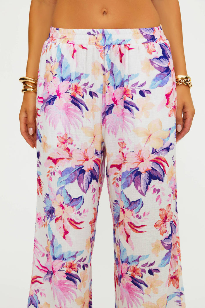 Colorful floral pants worn by a person on a white background