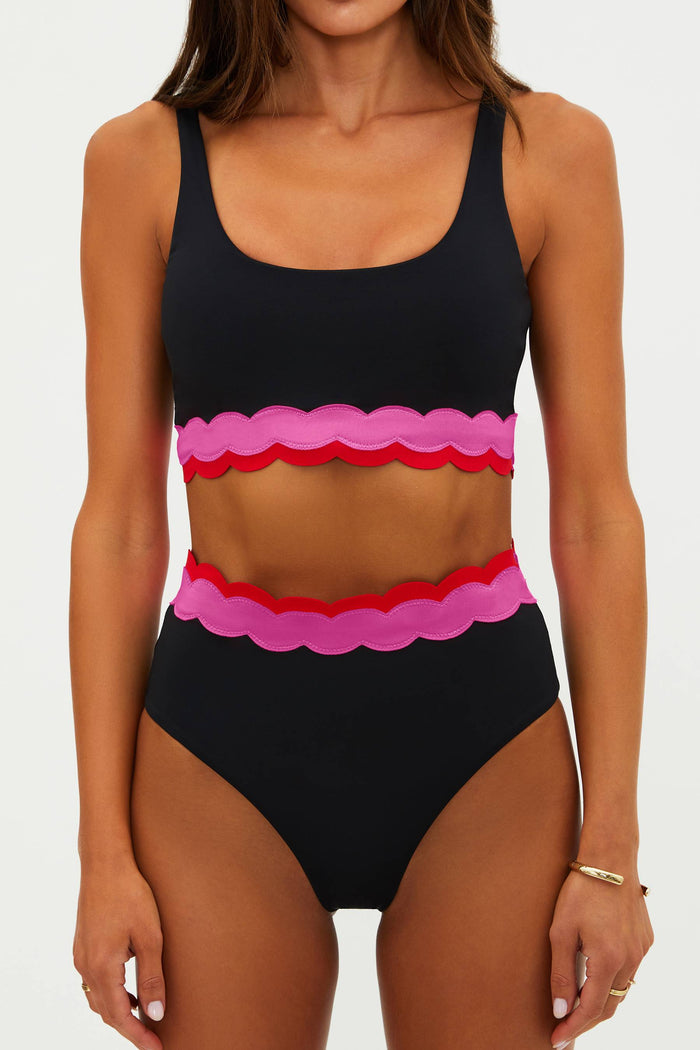 Black bikini with pink and red scalloped edges on a white background