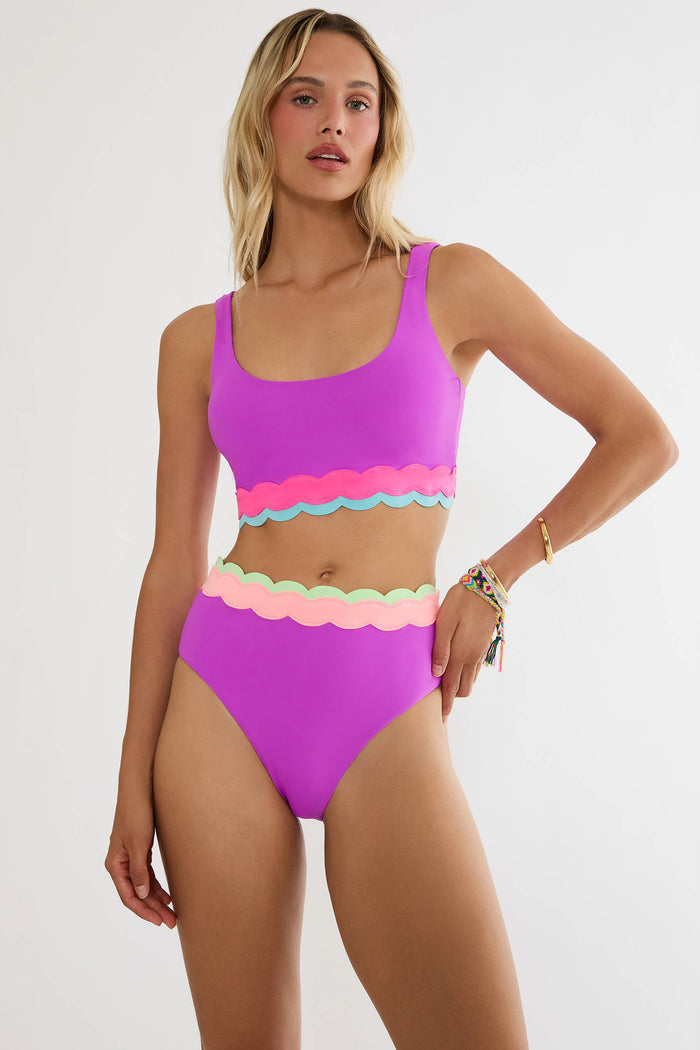 Woman wearing a colorful bikini set on a white background
