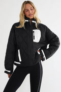 Black puffer zip up with beige detailing.