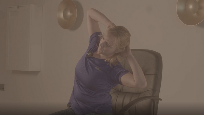 Close up shot of an instructor performing one of our seated hernia rehabilitation exercises.
