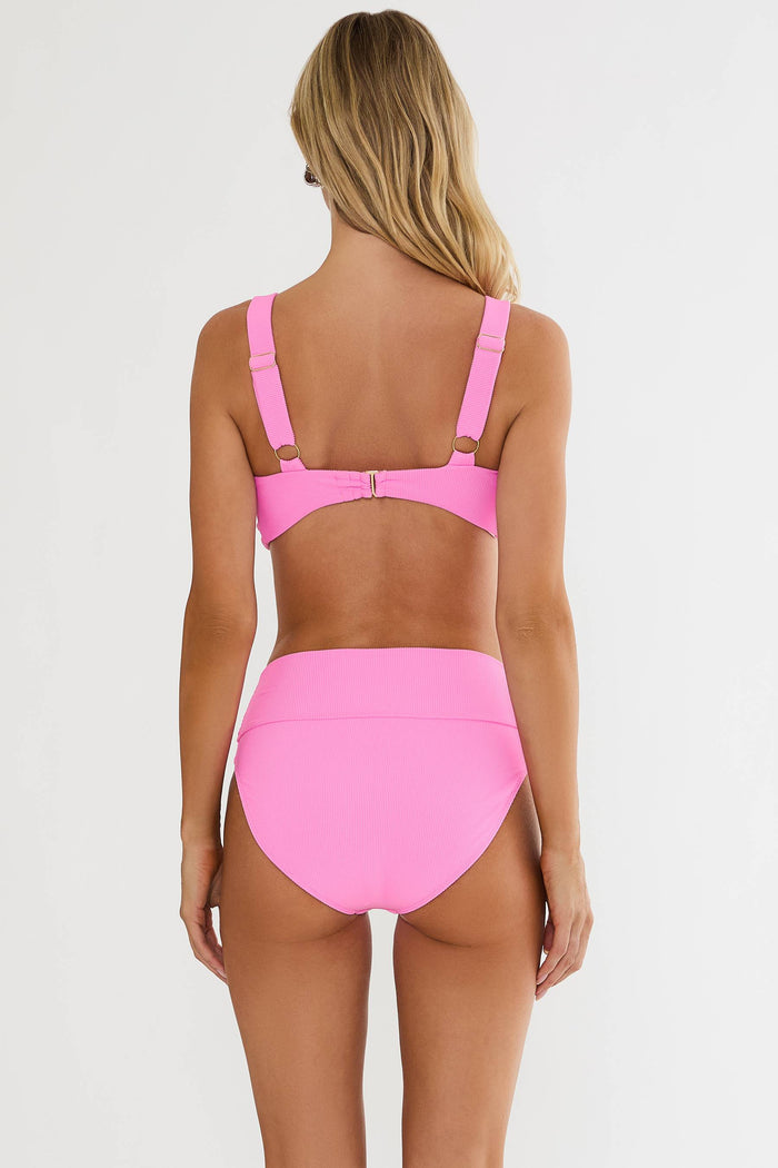 Person wearing a pink bikini set on a white background