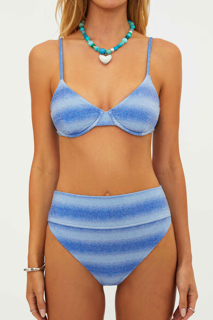 Woman wearing a blue striped bikini set on a white background