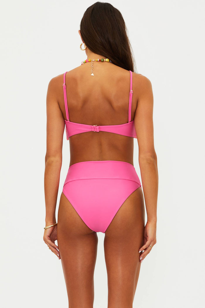Woman wearing a pink bikini on a white background