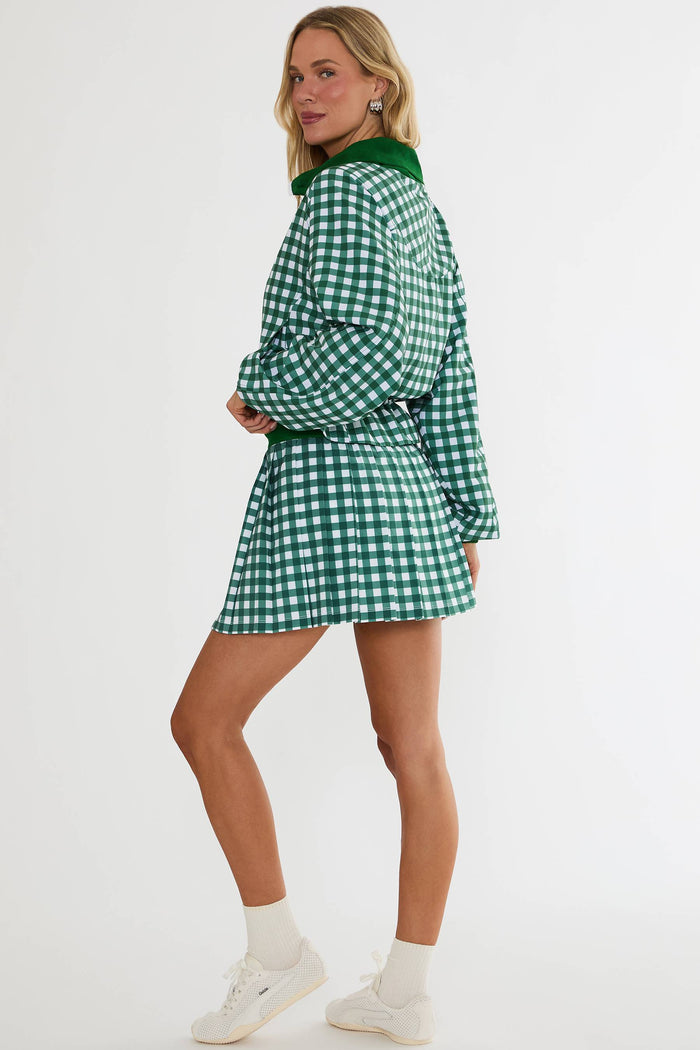 Woman wearing a green checkered dress on a white background