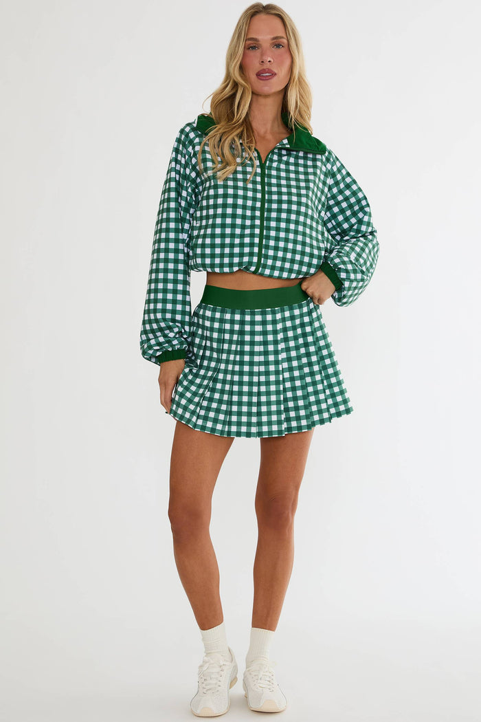 Woman wearing a green and white checkered outfit on a white background