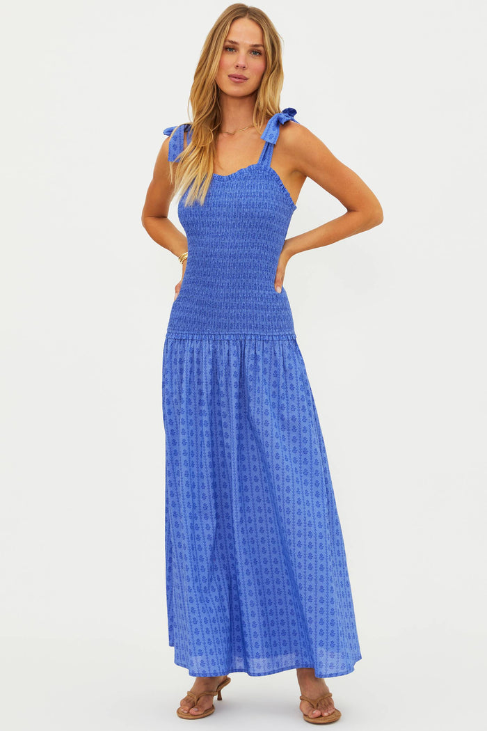 Woman wearing a blue patterned dress on a white background