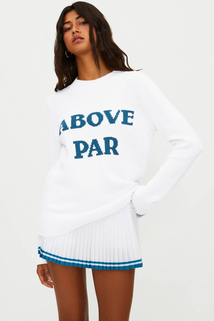 Woman wearing a white sweater with 'ABOVE PAR' text on a white background