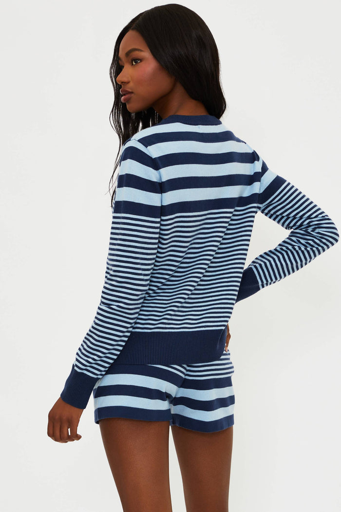 Woman wearing a blue and white striped outfit on a white background