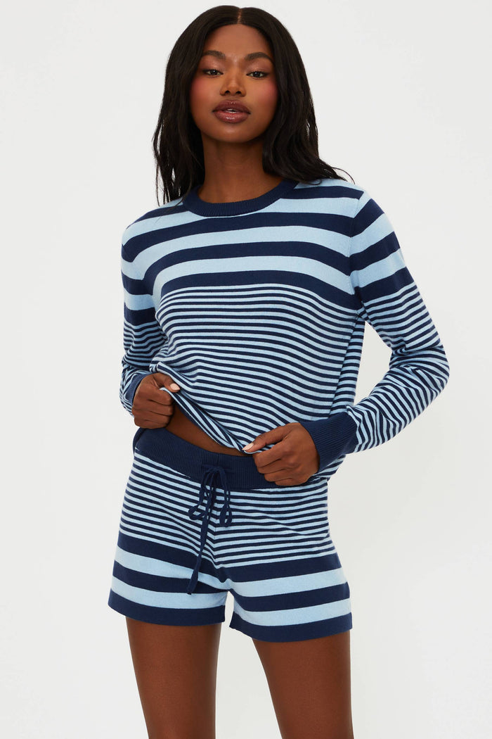 Woman wearing a blue and white striped pajama set on a white background