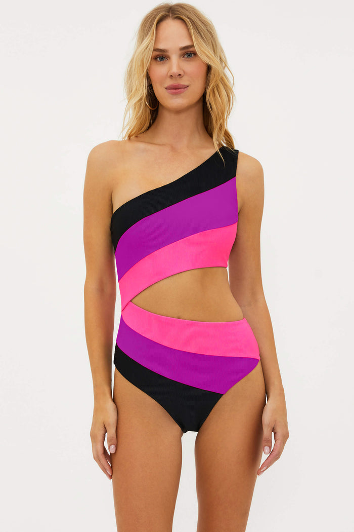 Woman wearing a colorful one-shoulder swimsuit on a white background