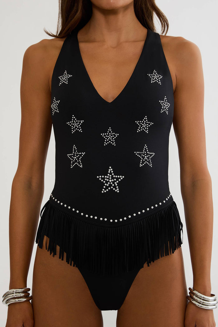Black swimsuit with star patterns and fringes on a white background