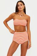 Woman wearing a striped two-piece swimsuit on a plain background