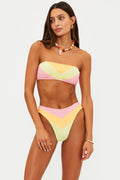Woman wearing a colorful bikini set on a plain background