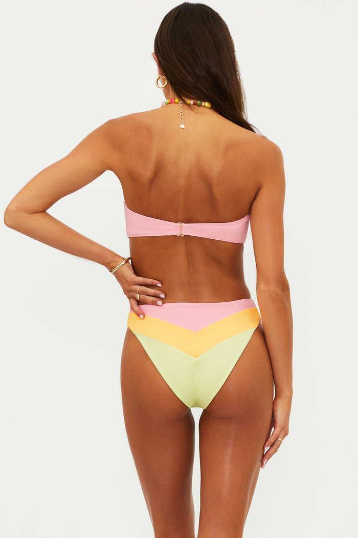 Woman wearing a colorful bikini set on a white background