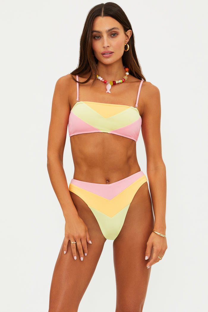 Woman wearing a colorful bikini set on a white background