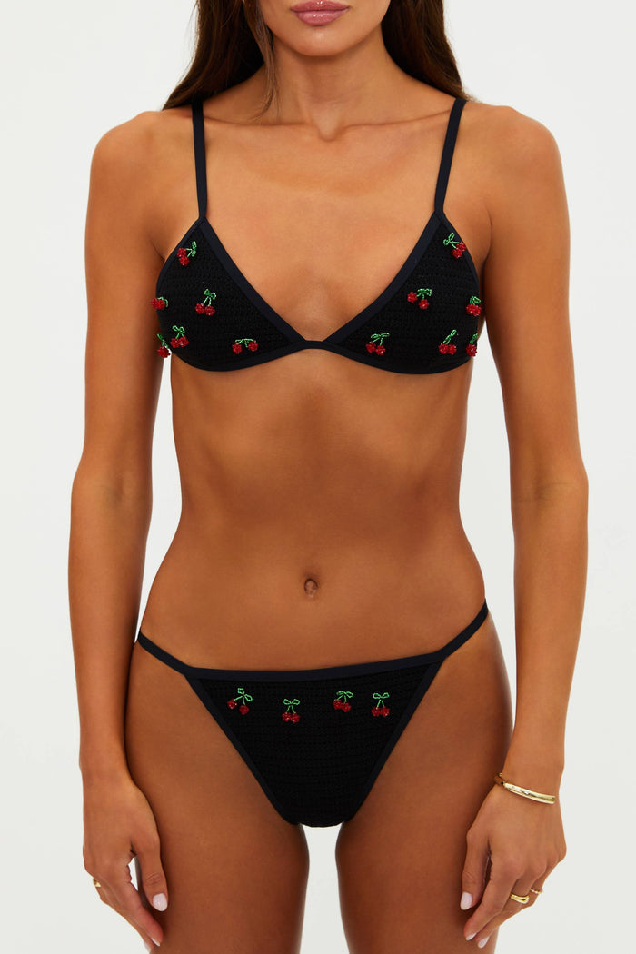 Black bikini with cherry embroidery on a white background