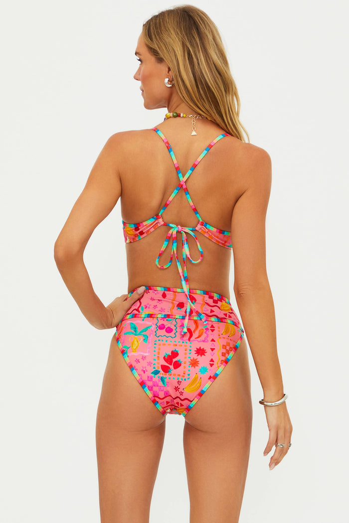 Woman wearing a colorful bikini with a white background