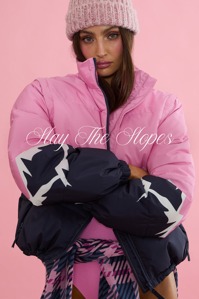 Pink and navy puffer jacket with white patterns