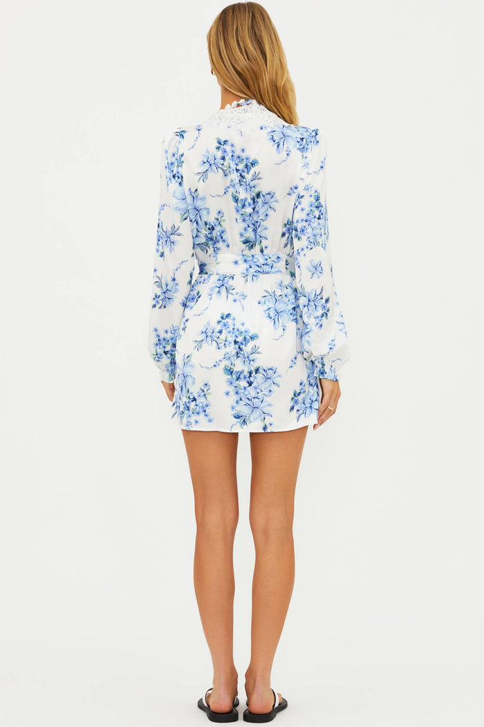 Woman wearing a blue floral dress on a white background