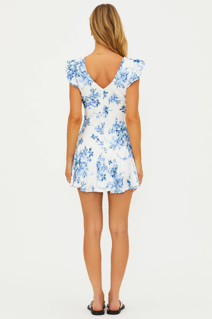 Woman wearing a blue floral dress on a white background