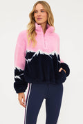 Woman wearing a pink and navy tie-dye fleece pullover on a white background