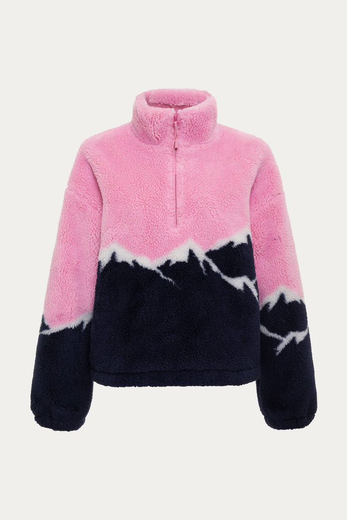 Woman wearing a pink and navy tie-dye fleece pullover on a white background