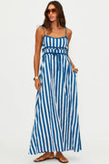 Woman wearing a blue and white striped dress on a white background