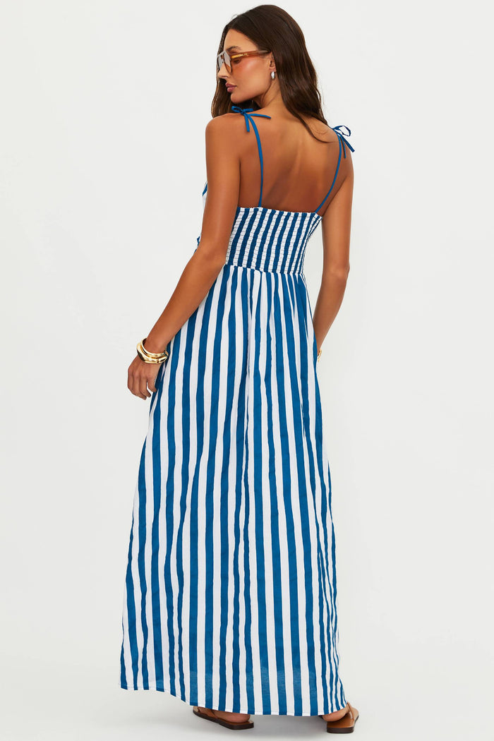 Woman wearing a blue and white striped dress on a white background
