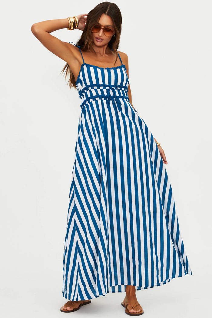 Woman wearing a blue and white striped dress on a white background
