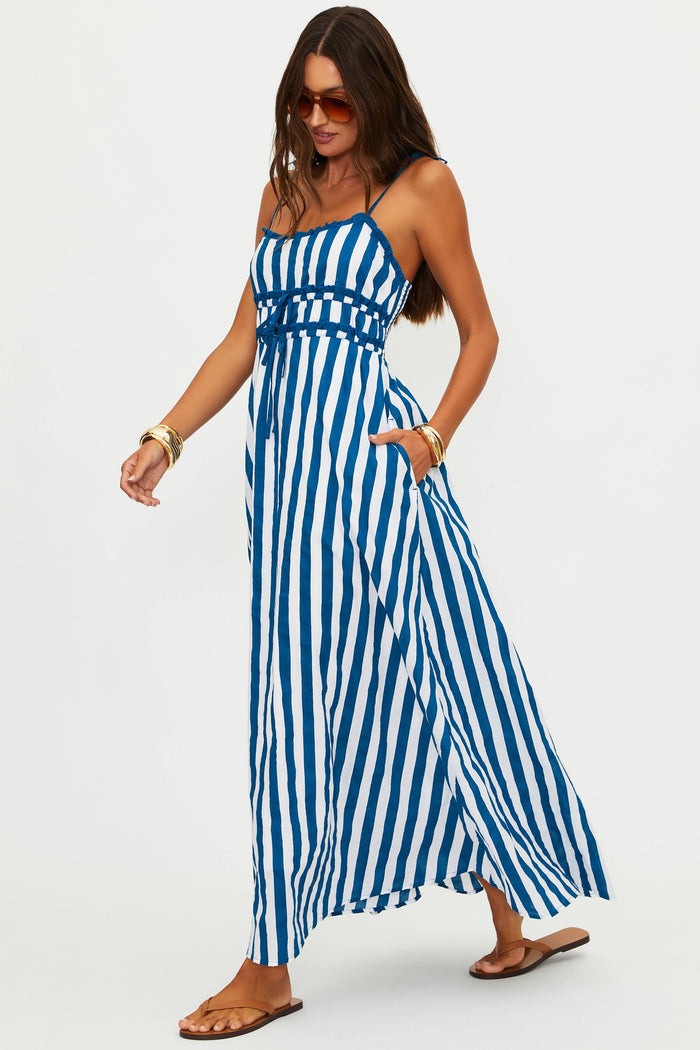 Woman wearing a blue and white striped dress on a white background