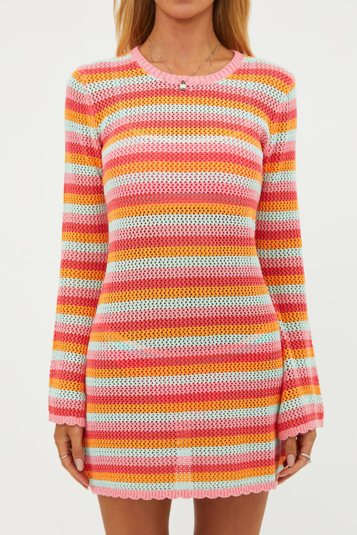 Multicolored striped sweater dress worn by a person on a plain background
