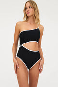 Woman wearing a black and white one-piece swimsuit on a white background