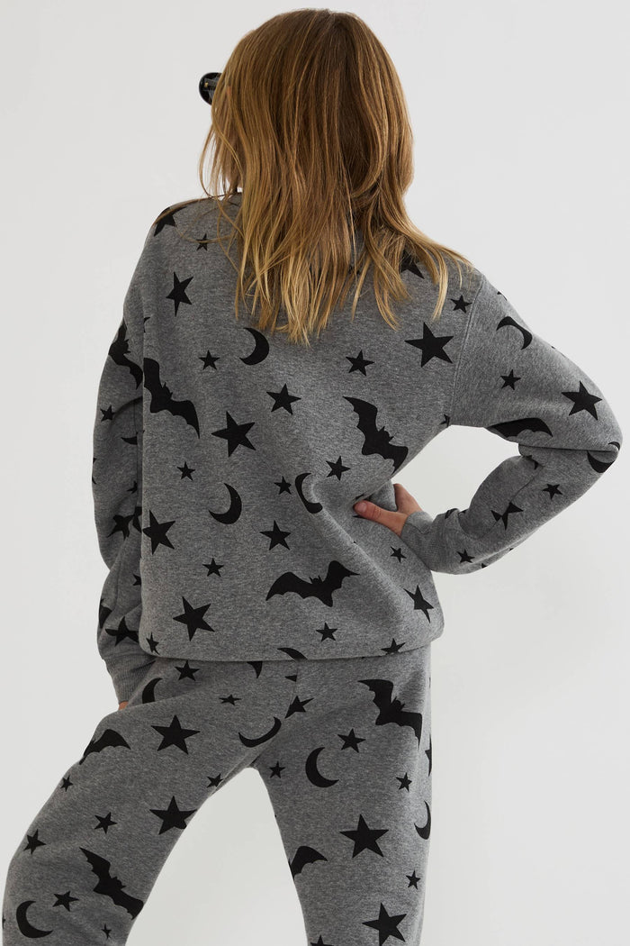 Kids grey sweatshirt with black stars, moons, and bats.