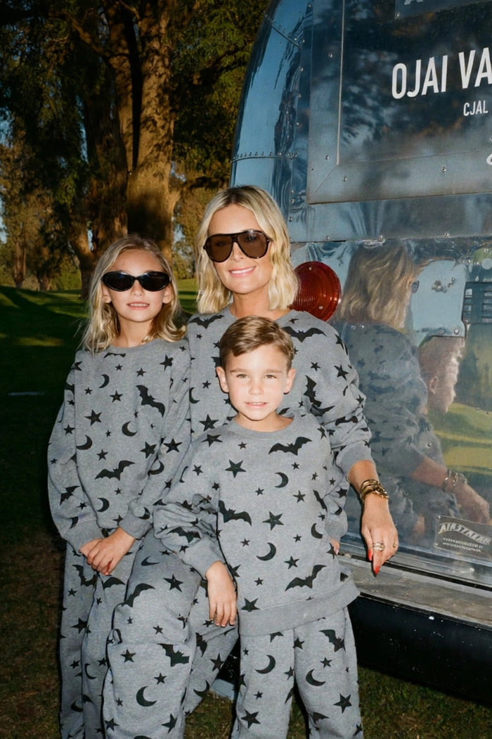 family wearing matching grey halloween sweat sets
