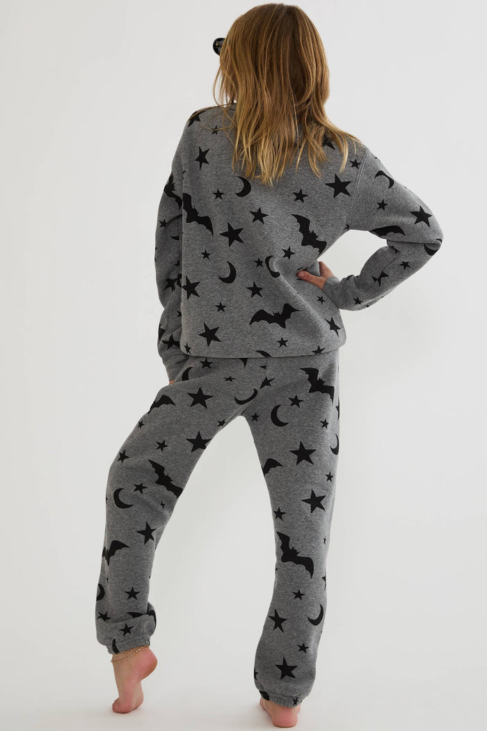 Kids grey sweatpants with black stars, moon, and bats.