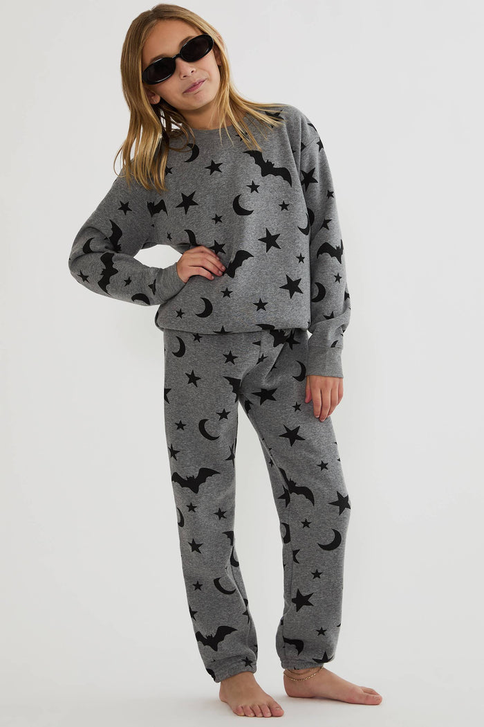 Kids grey sweatpants with black stars, moon, and bats.