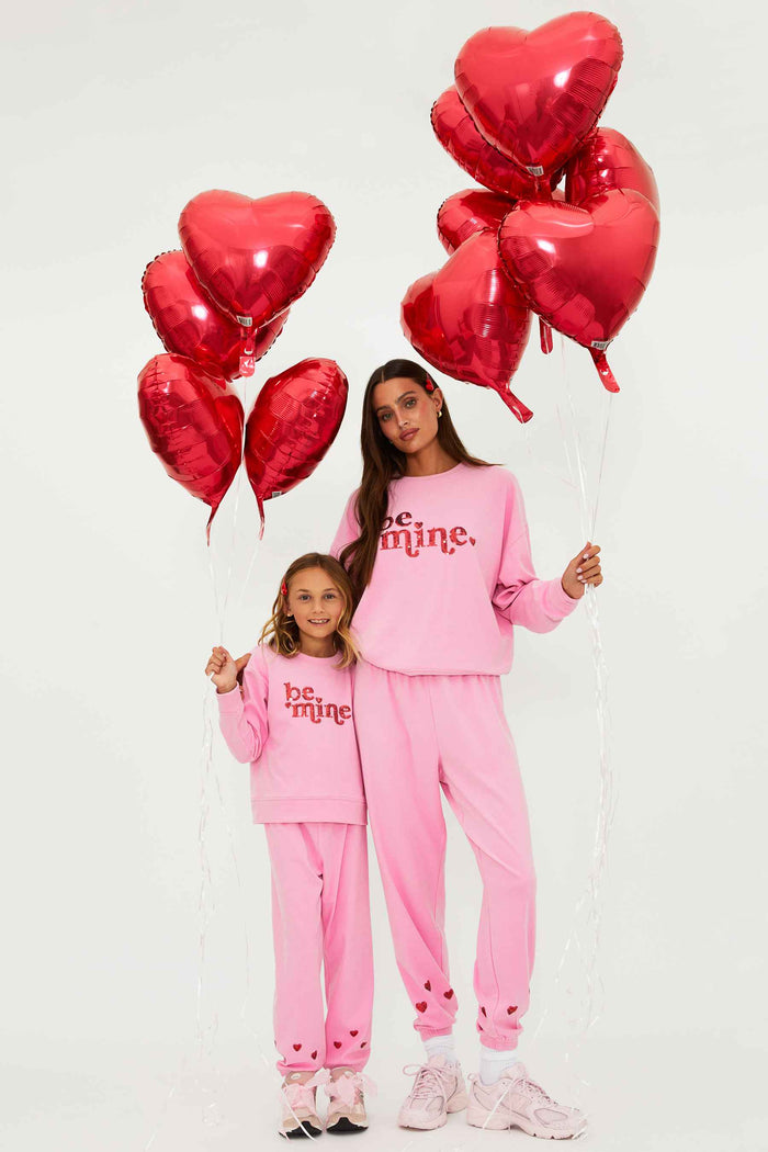 Pink sweatshirt with red glitter "be mine" text