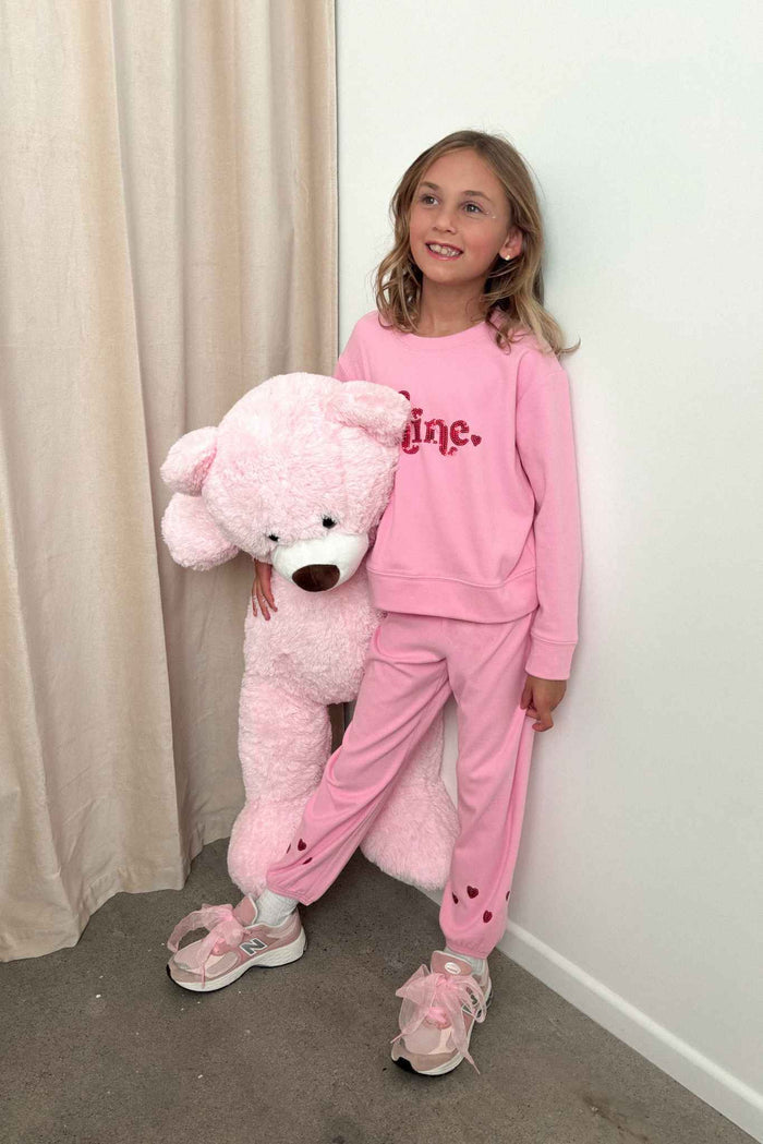 Pink sweatshirt with red glitter "be mine" text