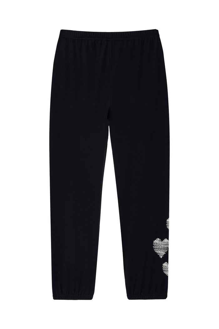 Black jogger pants with a white textured heart pattern on the lower left leg, shown flat against a white background.