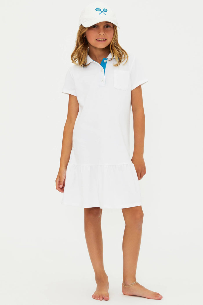 Young girl wearing a white dress with a blue collar on a white background