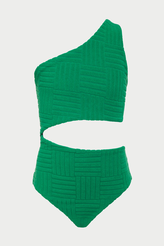 A child model wearing a one-shoulder asymmetrical green swimsuit with a side cut-out detail, paired with sunglasses and colorful bracelets.