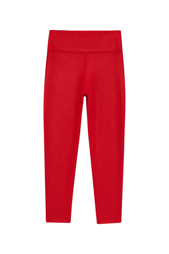 Red leggings with a subtle pattern on a white background