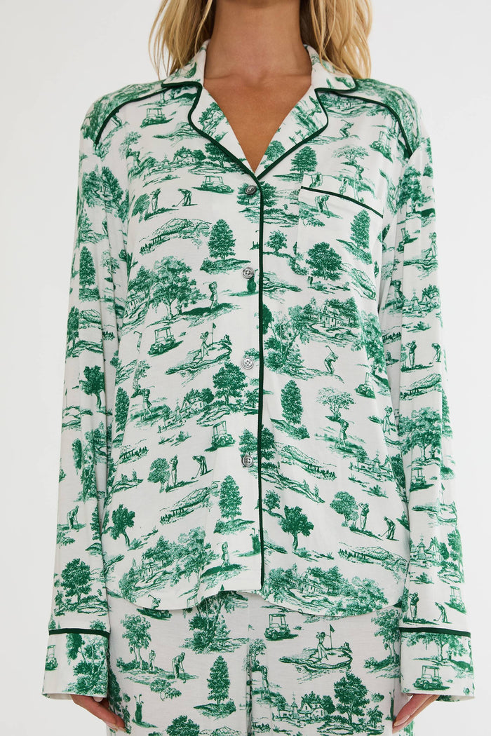 Green and white patterned pajama set worn by a person