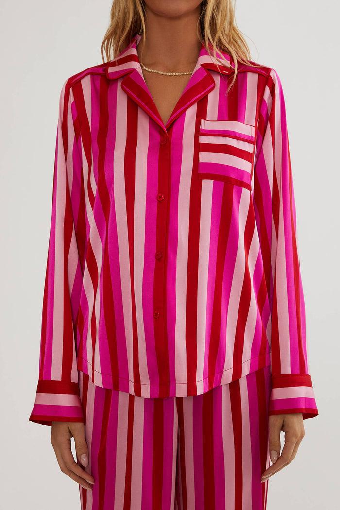 Person wearing a pink and red striped outfit on a white background