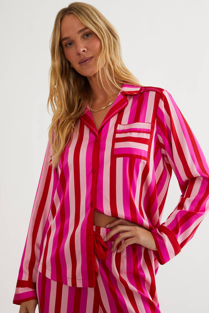 Woman wearing a pink and red striped outfit on a white background