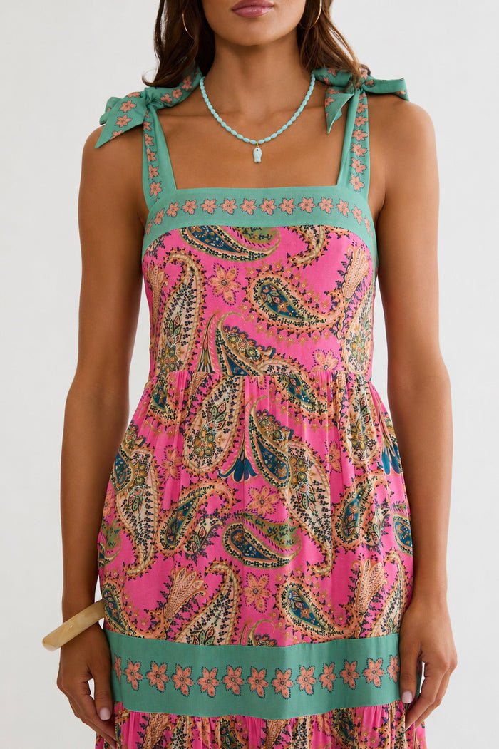 woman wearing a blue beaded fish necklace
