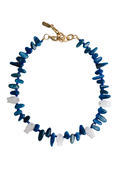 A beaded necklace featuring alternating translucent blue and opaque white disc-shaped beads, finished with a gold-tone lobster clasp, shown on a plain white background.