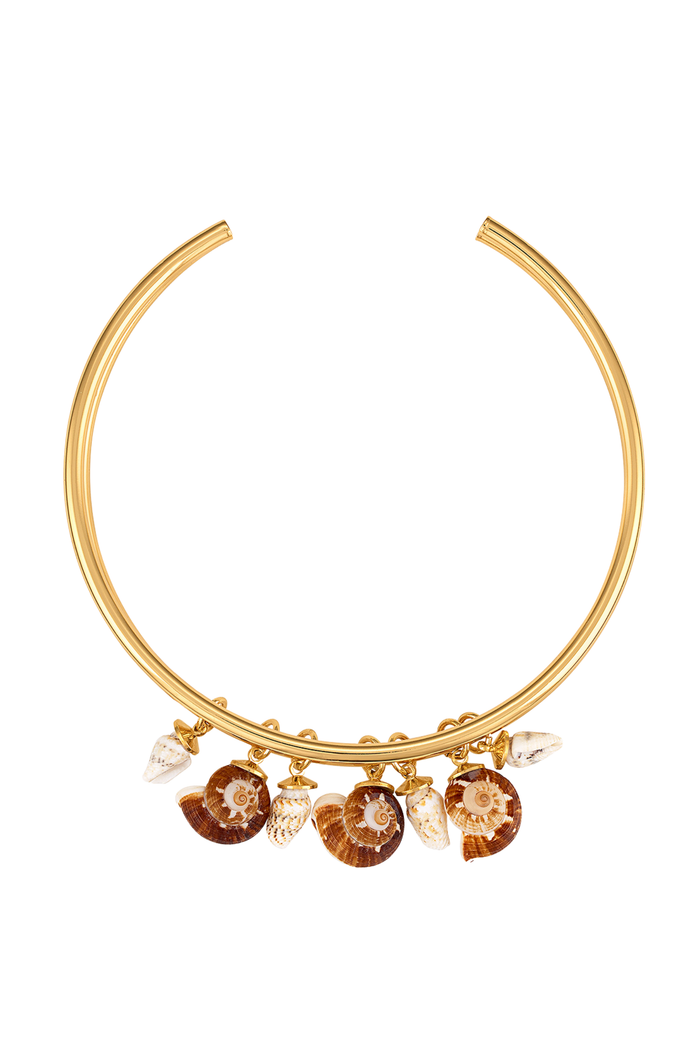 Gold-toned metal collar necklace with dangling shell and crystal charms, shown on a plain white background.